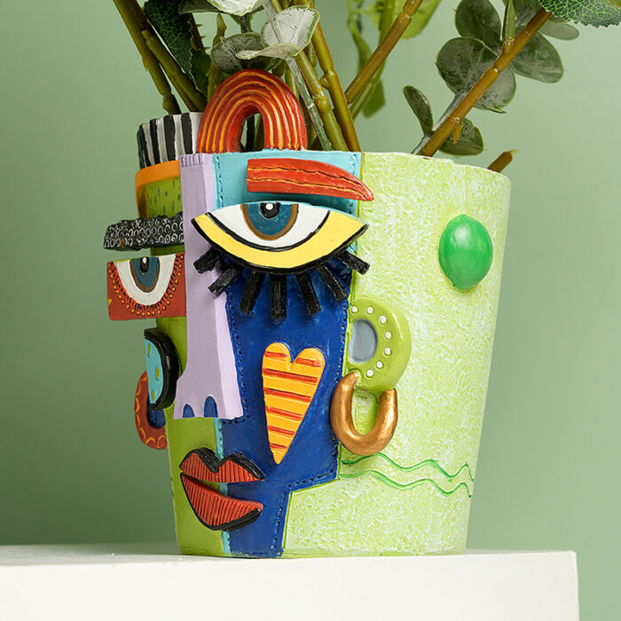 Hand-Painted Resin Face Planter for Succulents - Green Abstract Pot with 3D Eyes, Heart, Lips & Leafy Stems. Pop Art Indoor Plant Decor in Red, Blue, Yellow & Purple Geometric Patterns.