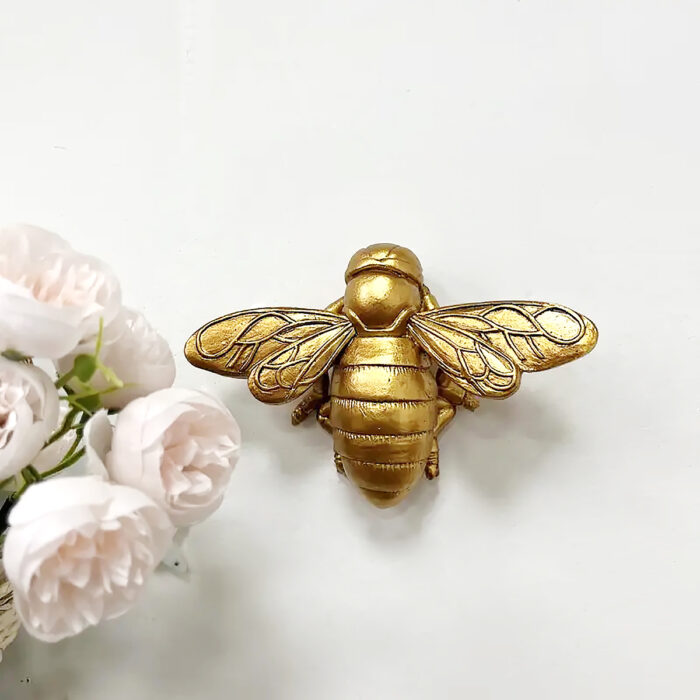 Golden resin bee wall sculpture with 3D honeycomb texture - Nature inspired epoxy decor for living room & nursery