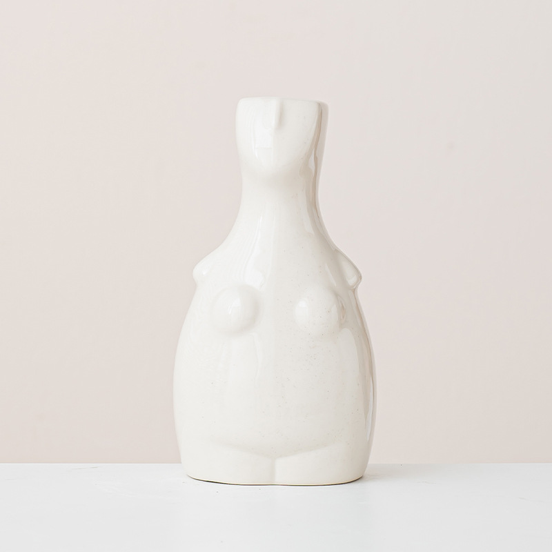 White abstract female bust ceramic vase with minimalist curves, clean beige background, modern sculptural planter